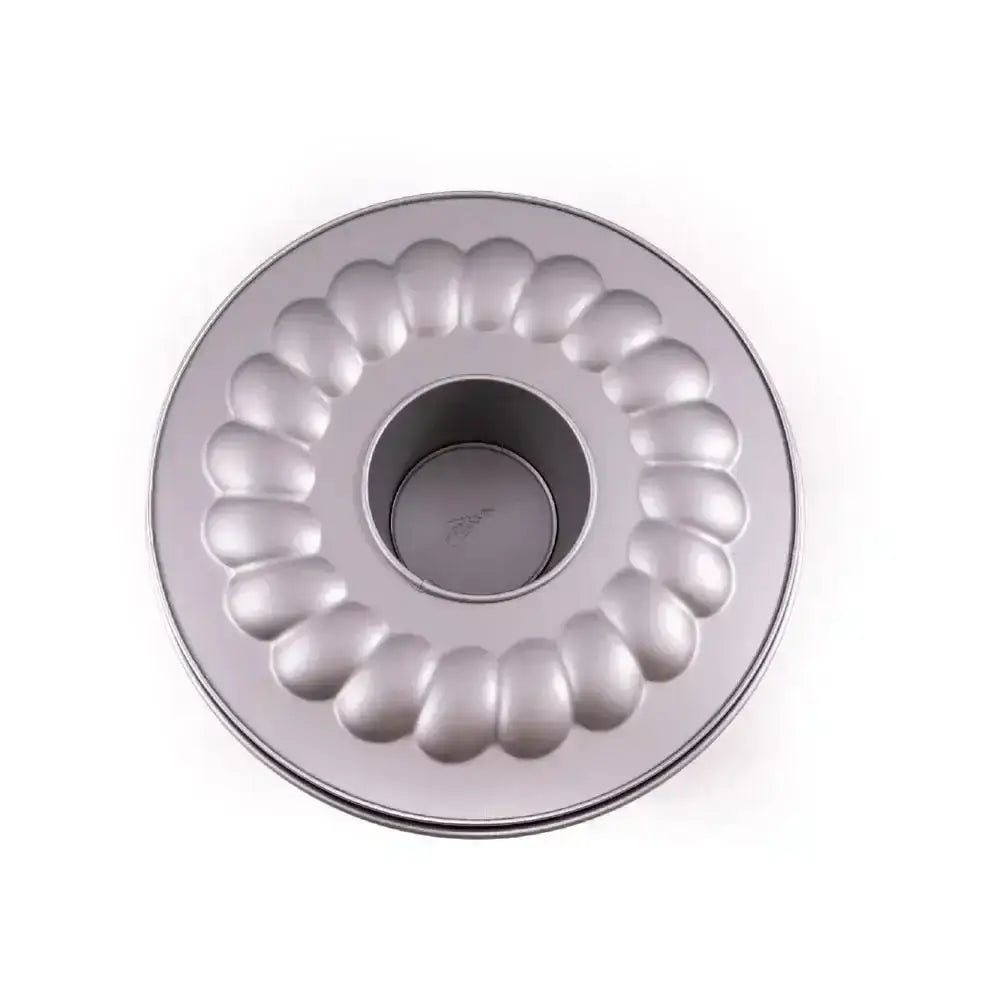 Metallic Bundt cake pan on a white background