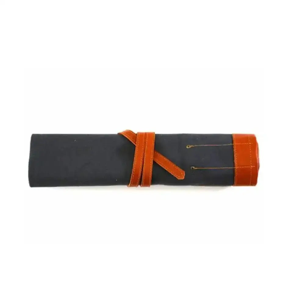 Black canvas knife roll with orange leather straps and trim by pieter de jager for secure tool storage
