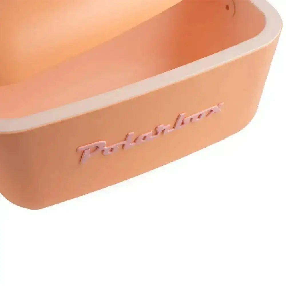 Peach-colored silicone polarbox classic retro cooler box with a light beige rim and 12 liter capacity