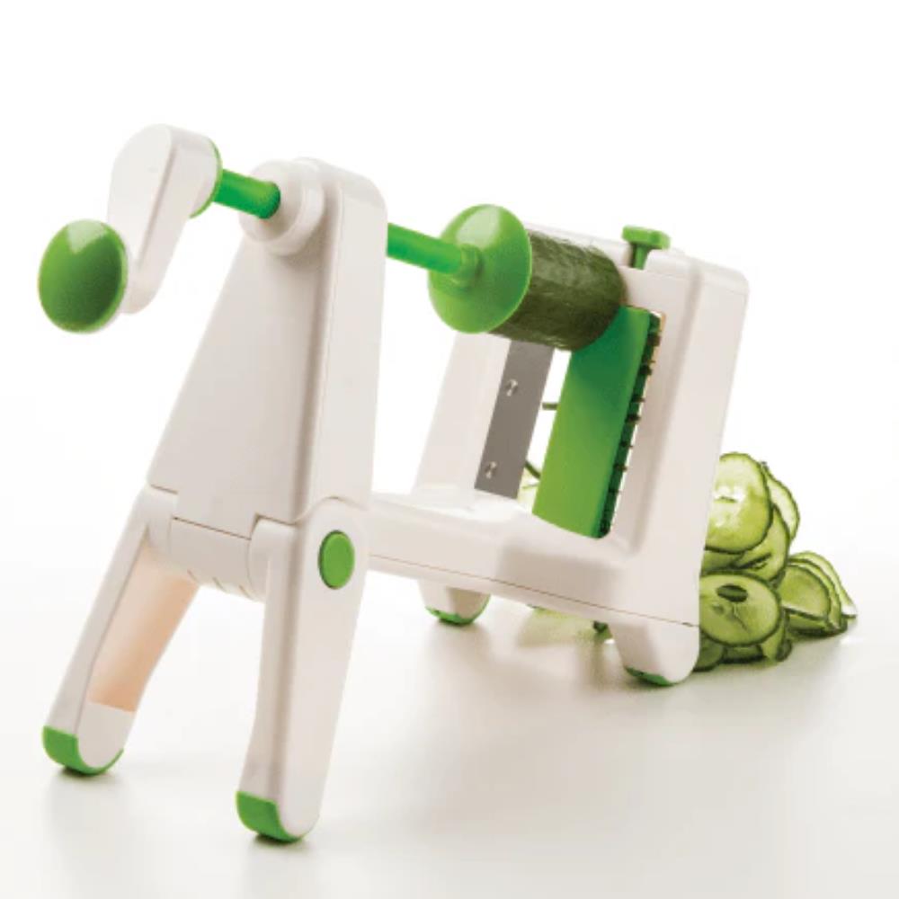 Green and white vegetable peeler with cucumbers on a white background