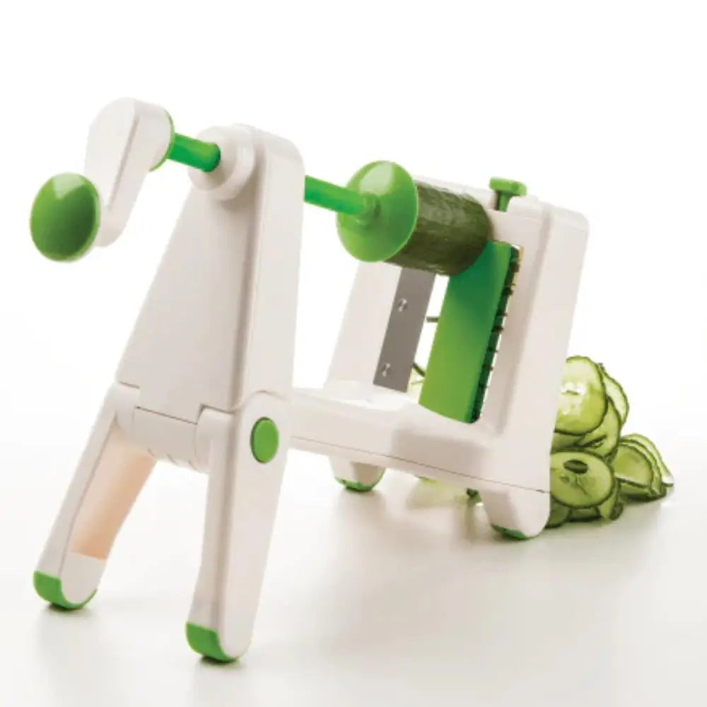 Green and white vegetable peeler with cucumbers on a white background