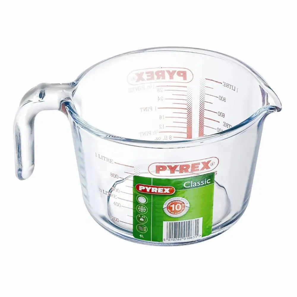 Clear glass measuring jug on a white background.