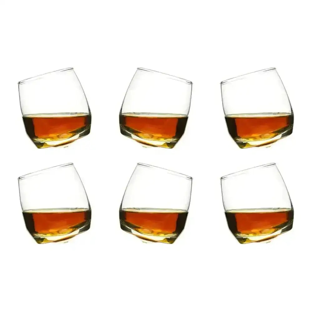 Six glasses filled with amber liquid on a white background