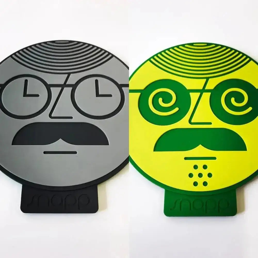 Two circular coasters with face designs, one gray and one green, on a white background.