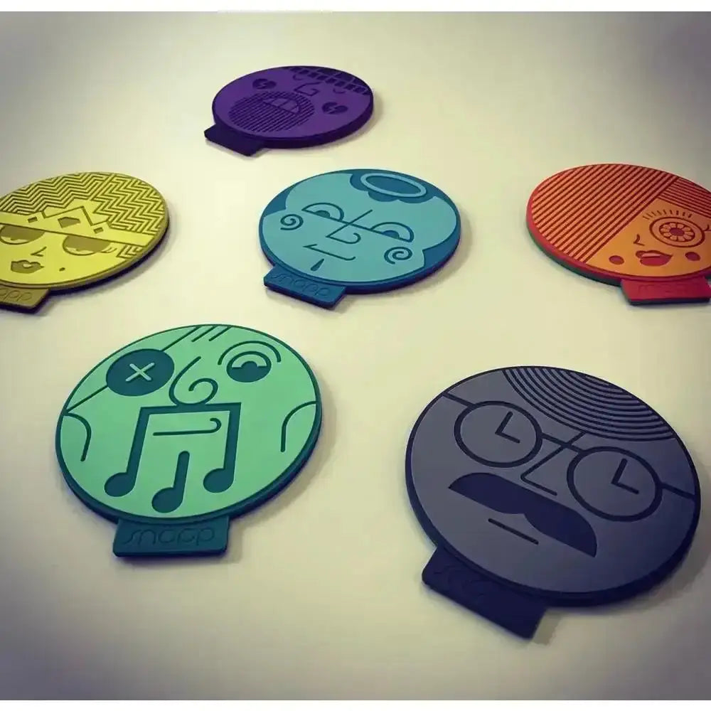 Colorful face-shaped coasters on a light background