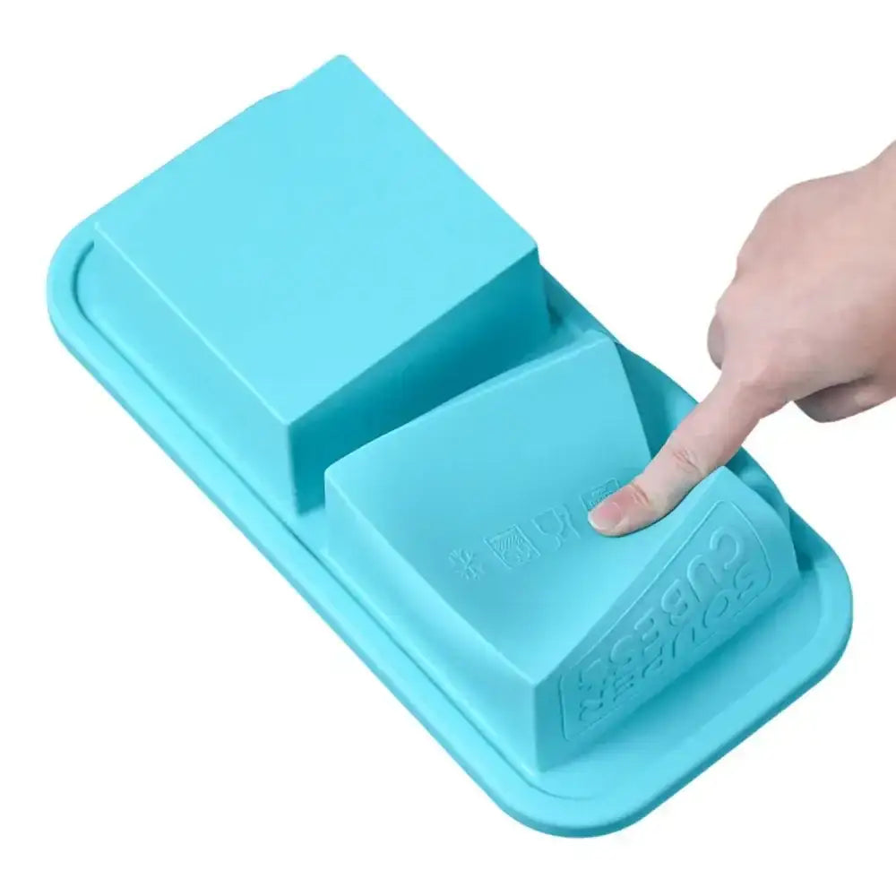 Blue silicone mold with a hand pressing down on it against a white background