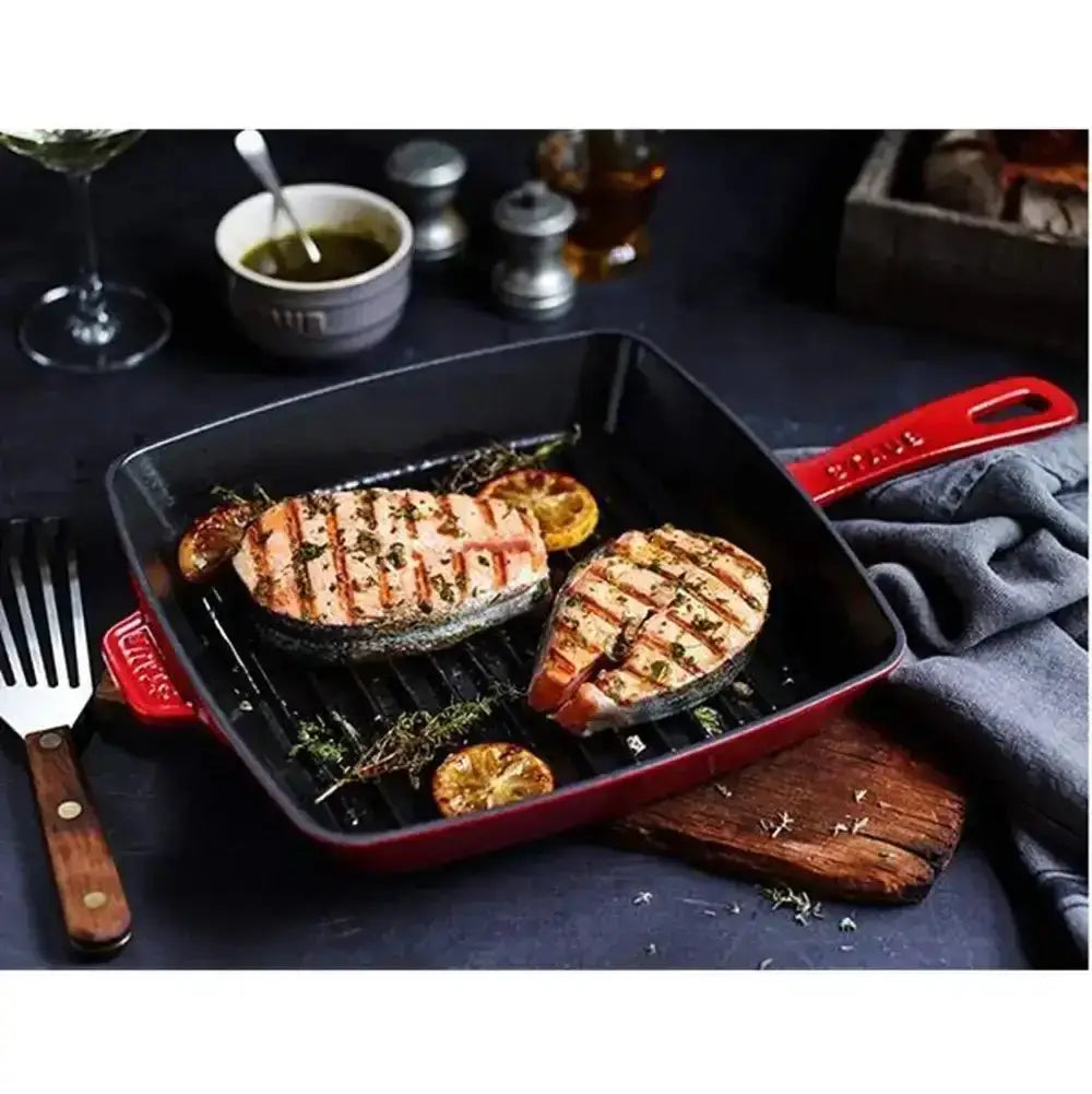 Staub American cast iron grill pan 26cm in red with sturdy handle and visible grilling ridges for searing