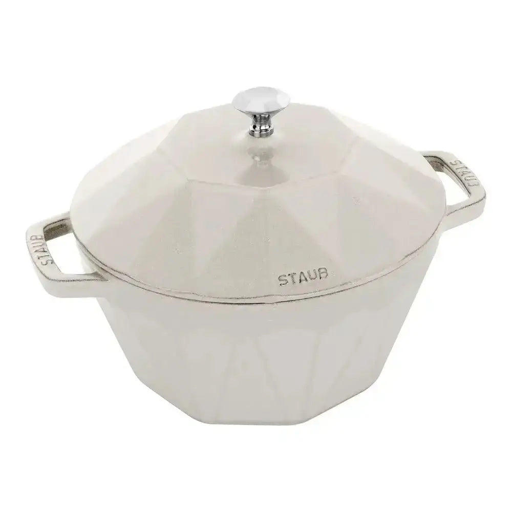White Staub cocotte with a lid on a white background