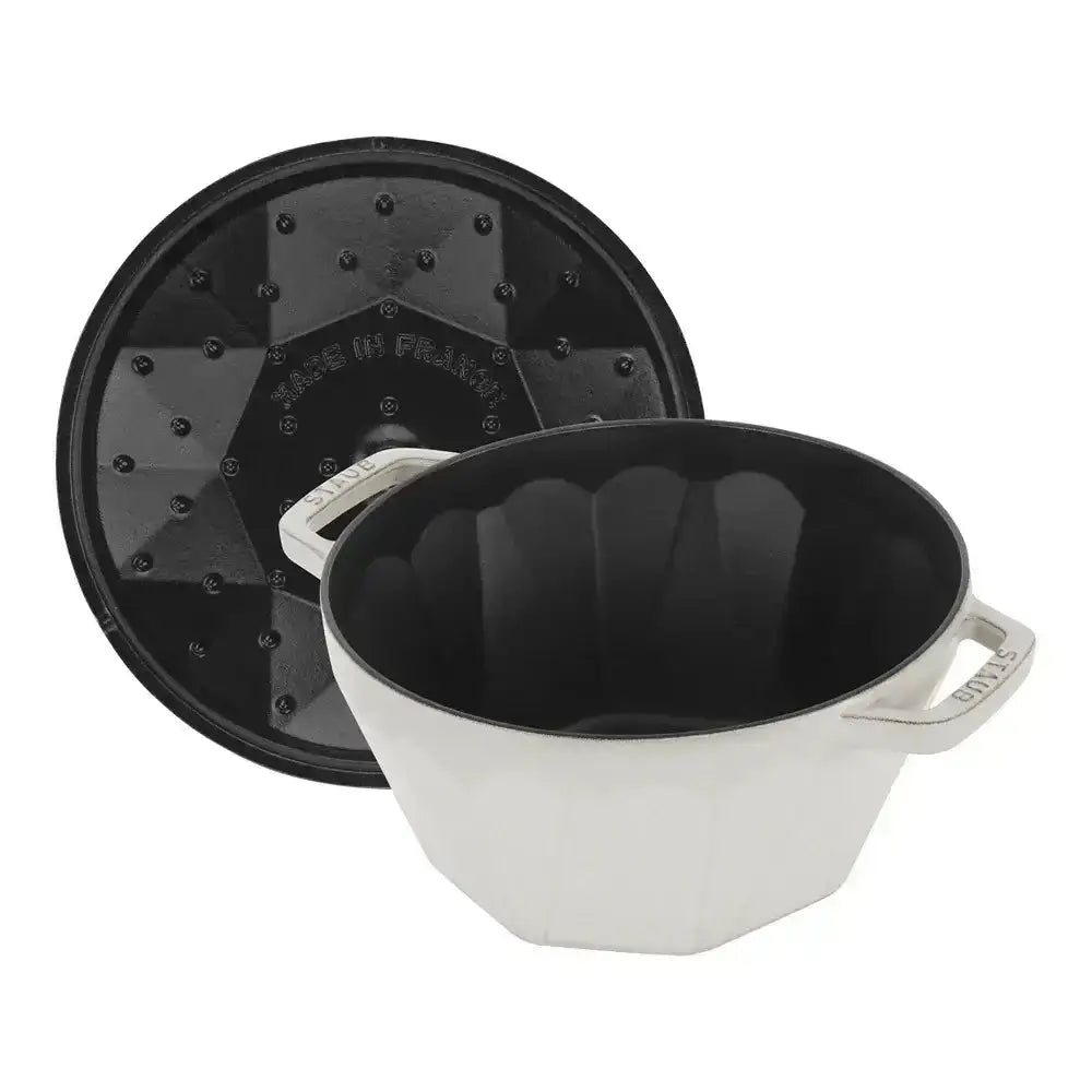 White pot with black lid on a white background