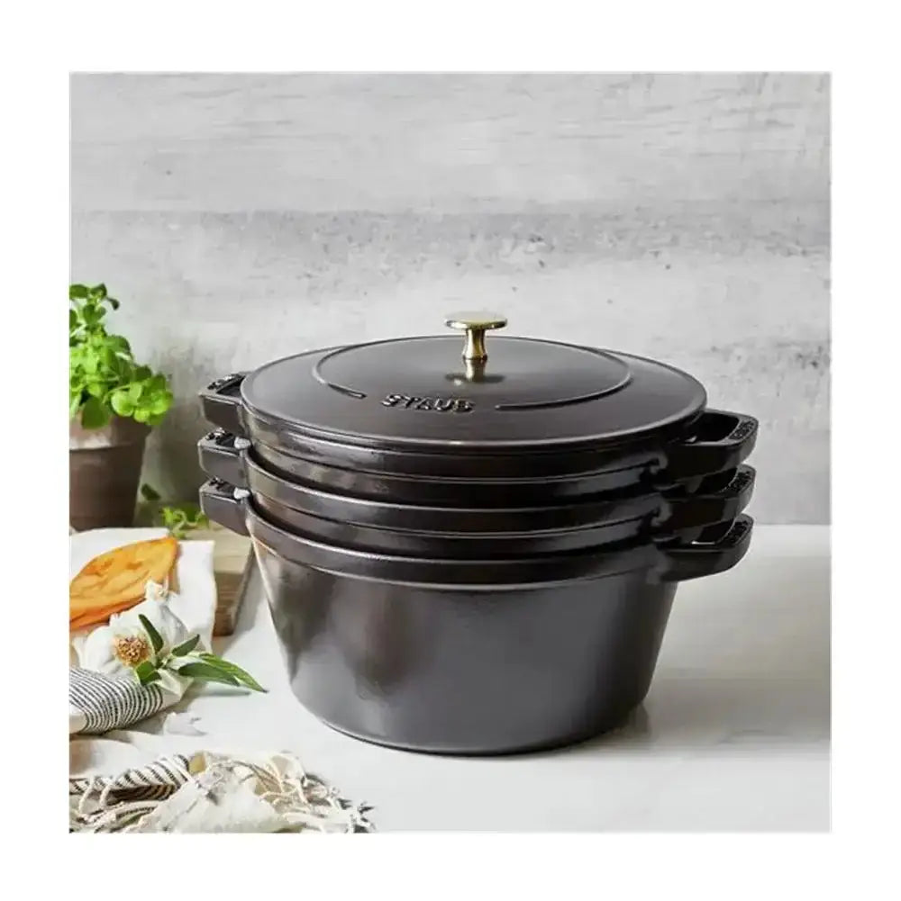 Black enameled cast iron staub cocotte with brass knob and side handles from the cast iron stackable cookware set
