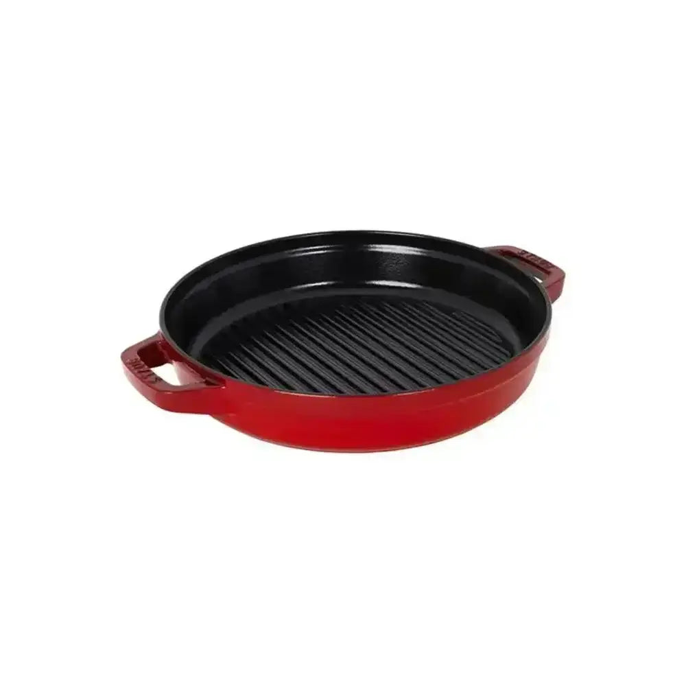 Red enameled cast iron grill pan with black ridged surface and side handles from staub stackable cookware set