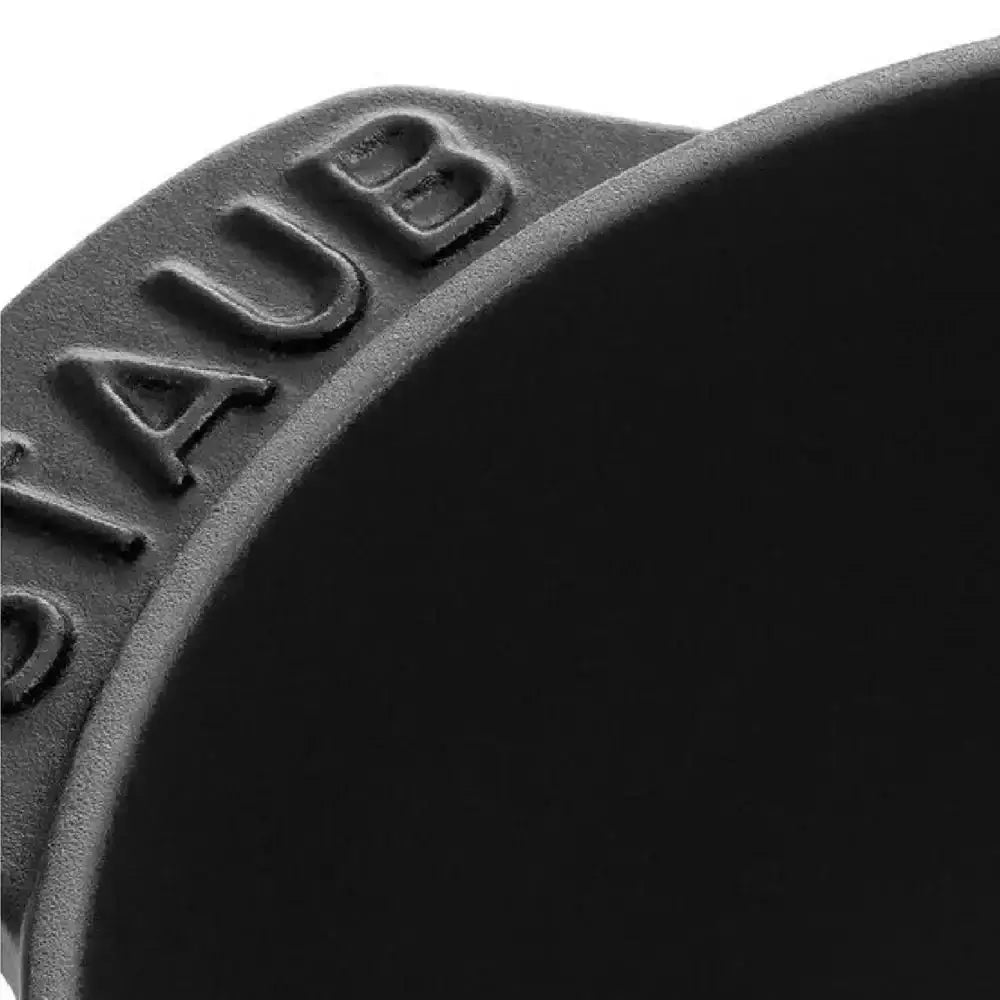 Black cast iron Staub oval dutch oven with embossed branding on the rim 2 liter mussel pot