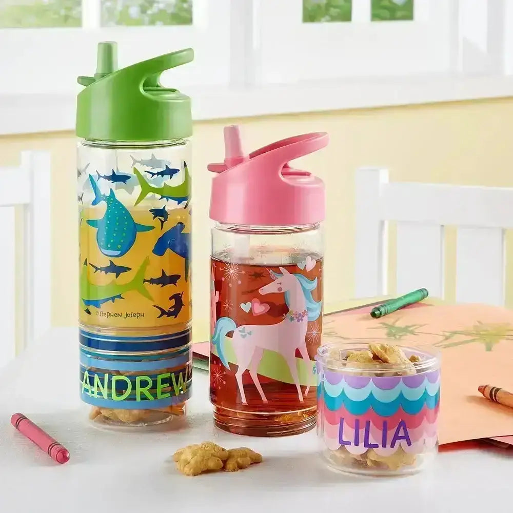 Three colorful water bottles with animal designs on a table.