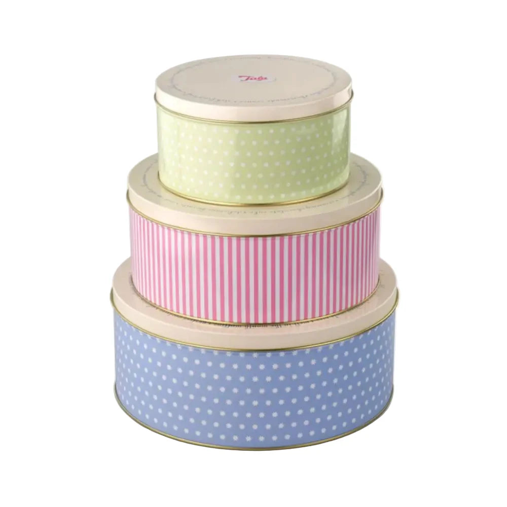 Set of three decorative tins with polka dot and striped patterns on a white background