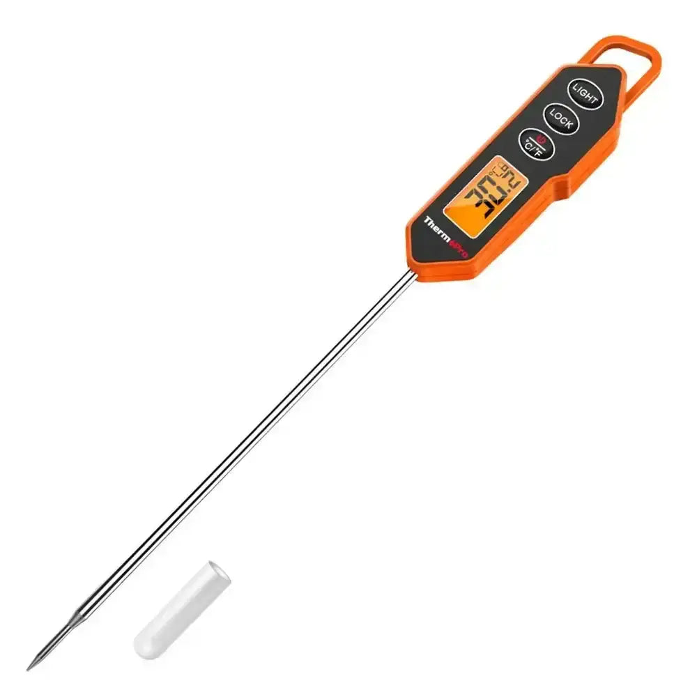 Digital instant read meat thermometer with orange handle and LCD display on white background