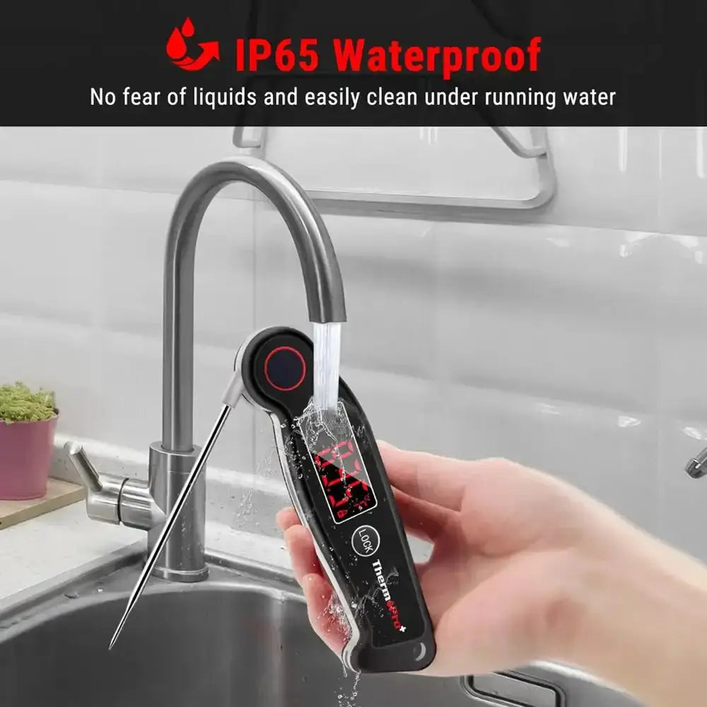 Digital thermometer being used to check water temperature in a kitchen sink with IP65 waterproof text above.