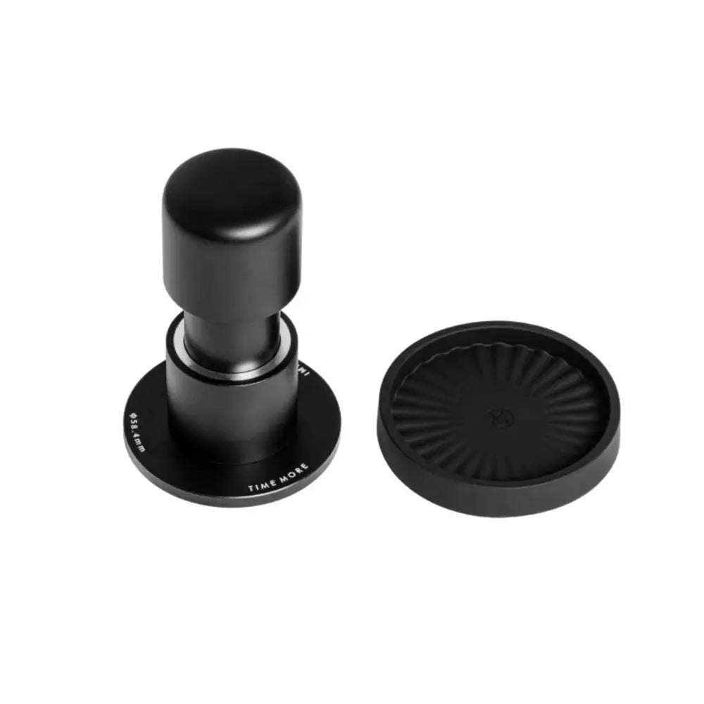 Black coffee tamp and lid on a white background