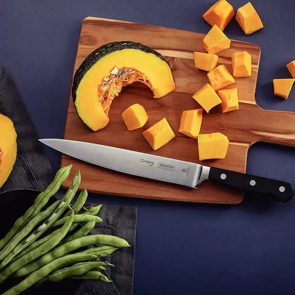 Butternut squash on a wooden cutting board with a knife, on a dark blue background