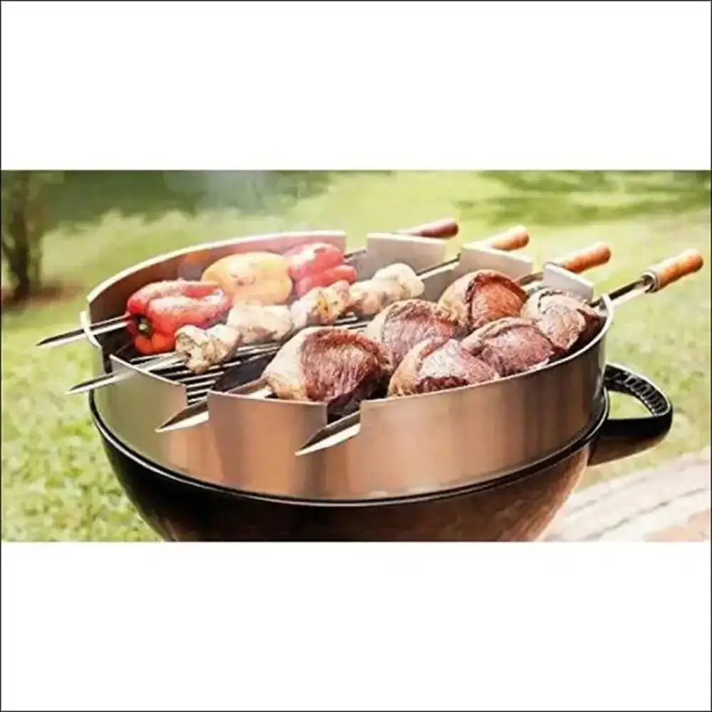 Outdoor grill with skewers of meat and vegetables on a grassy background
