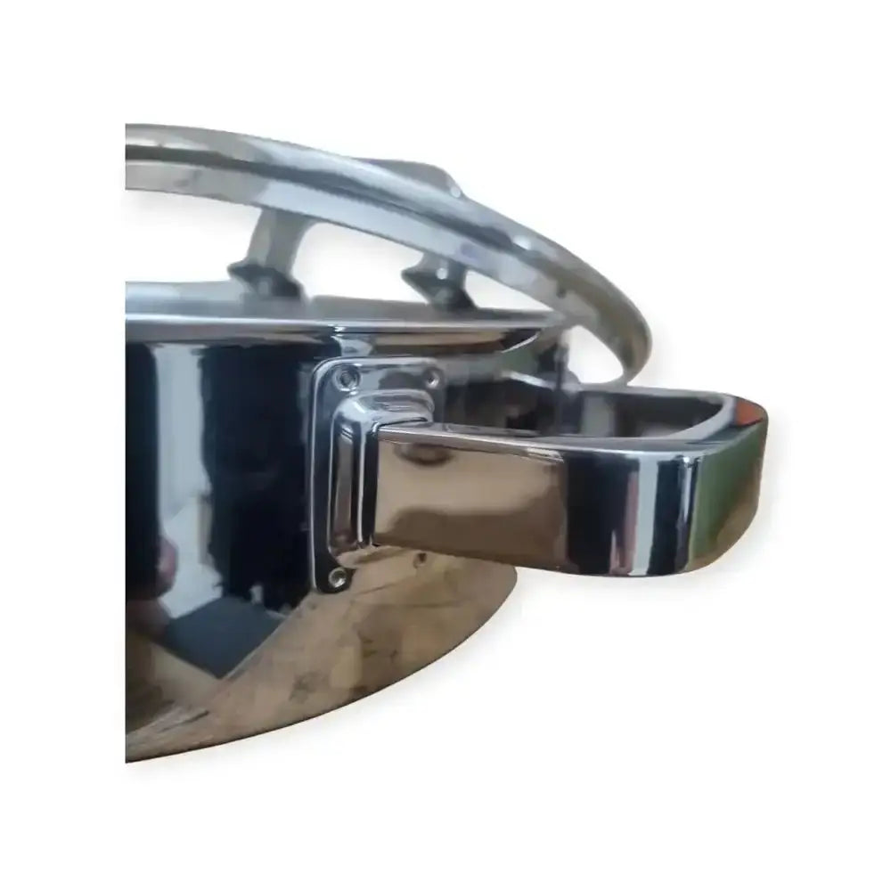 Close-up of a shiny metal pot handle on a white background