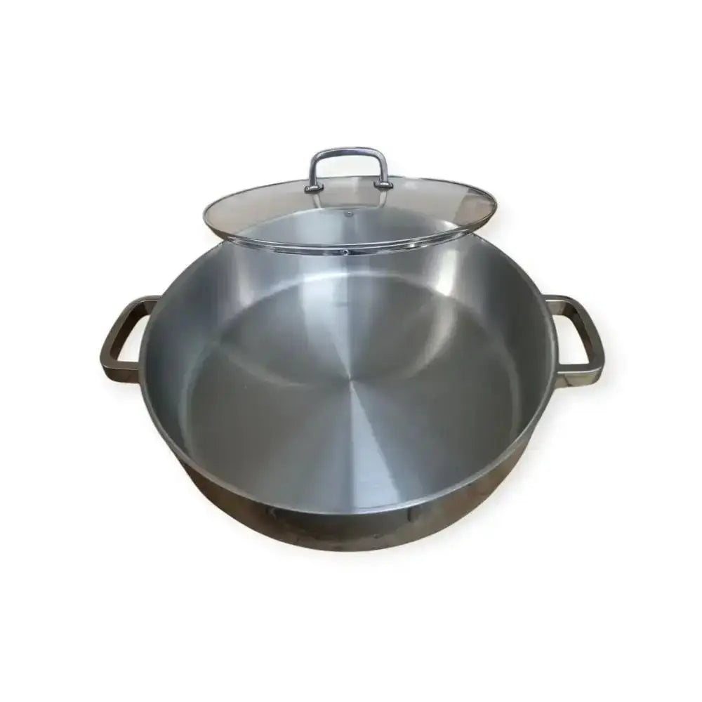 Stainless steel wok with lid on a white background