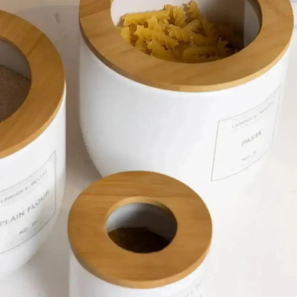 White ceramic typhoon eden canister small 500ml with natural wood lid labeled pasta filled with yellow spiral pasta