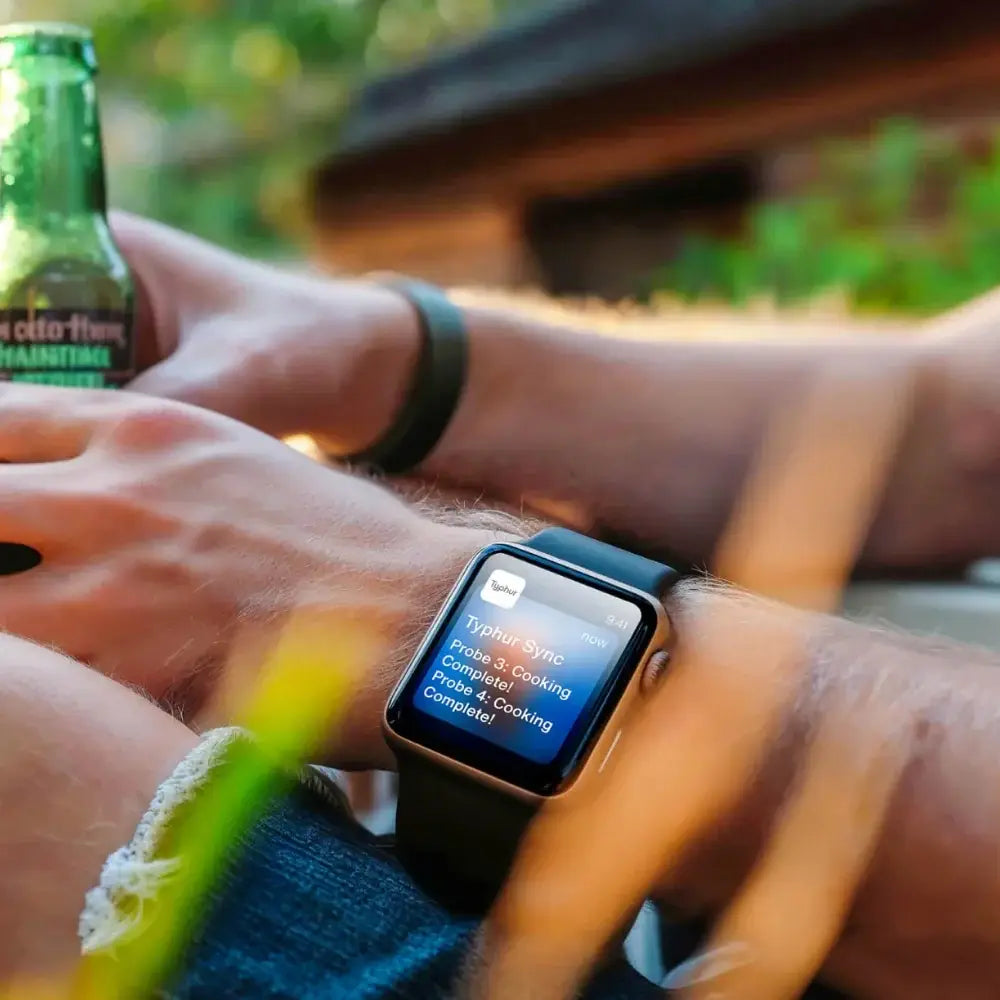 Typhur app displayed on a watch screen with a blurred nature background.