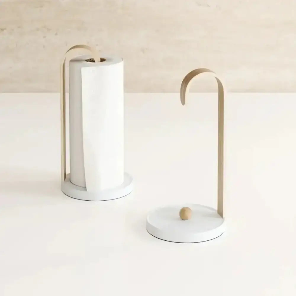 White paper towel holder with wooden accents on a white surface