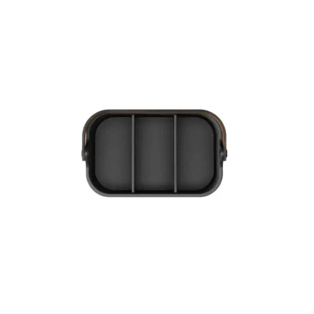 Black rectangular object with a textured surface on a white background