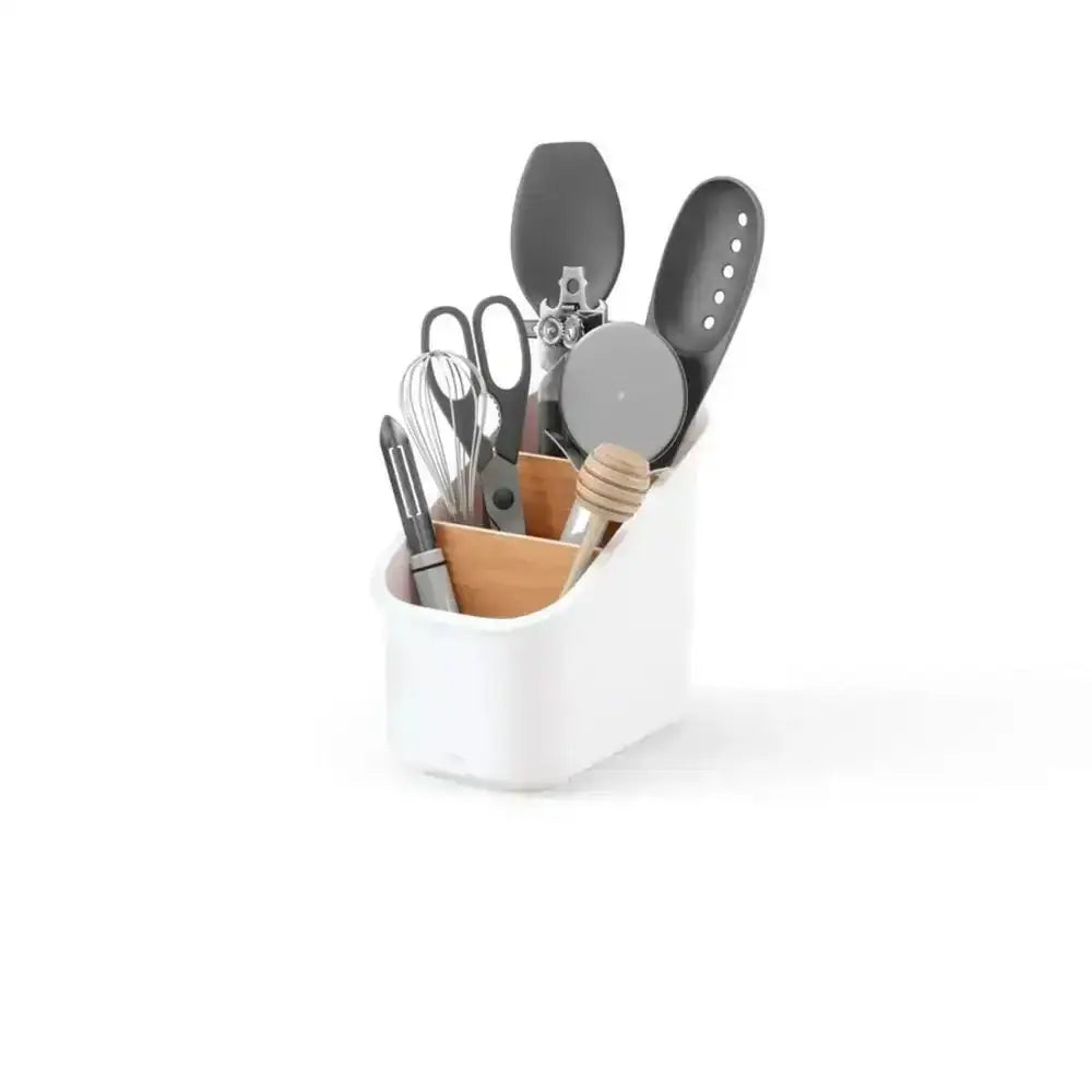 White kitchen utensil holder with various utensils on a white background
