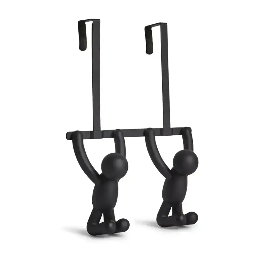 Black metal door hanger shaped like two people on a swing against a white background