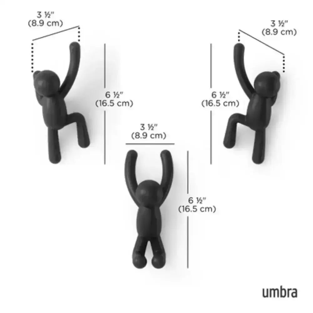 Black wall hooks shaped like people with measurements and 'umbra' branding.