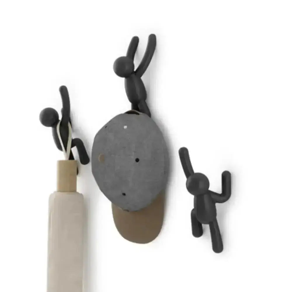 Set of wall hooks shaped like a person, a rock, and a stick figure on a white background.