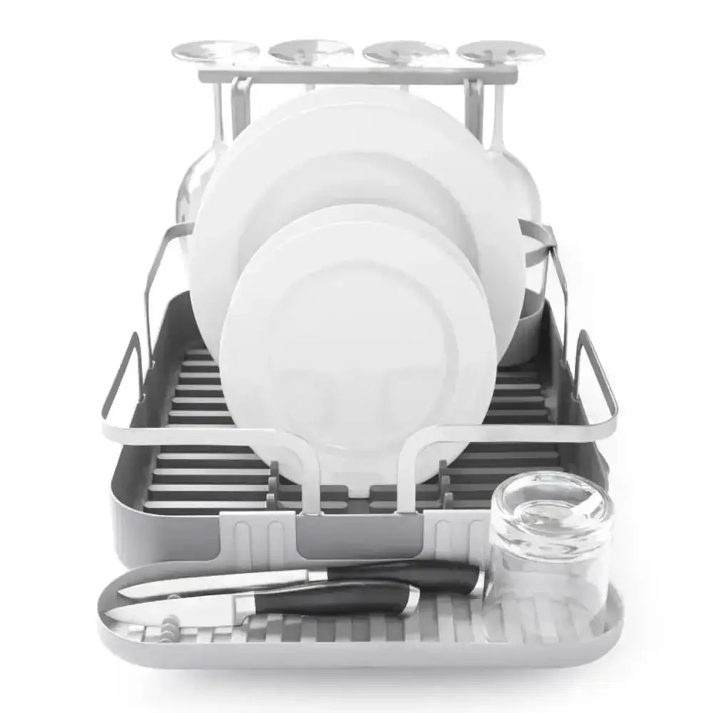 Dish drying rack with plates, bowls, and glasses on a white background