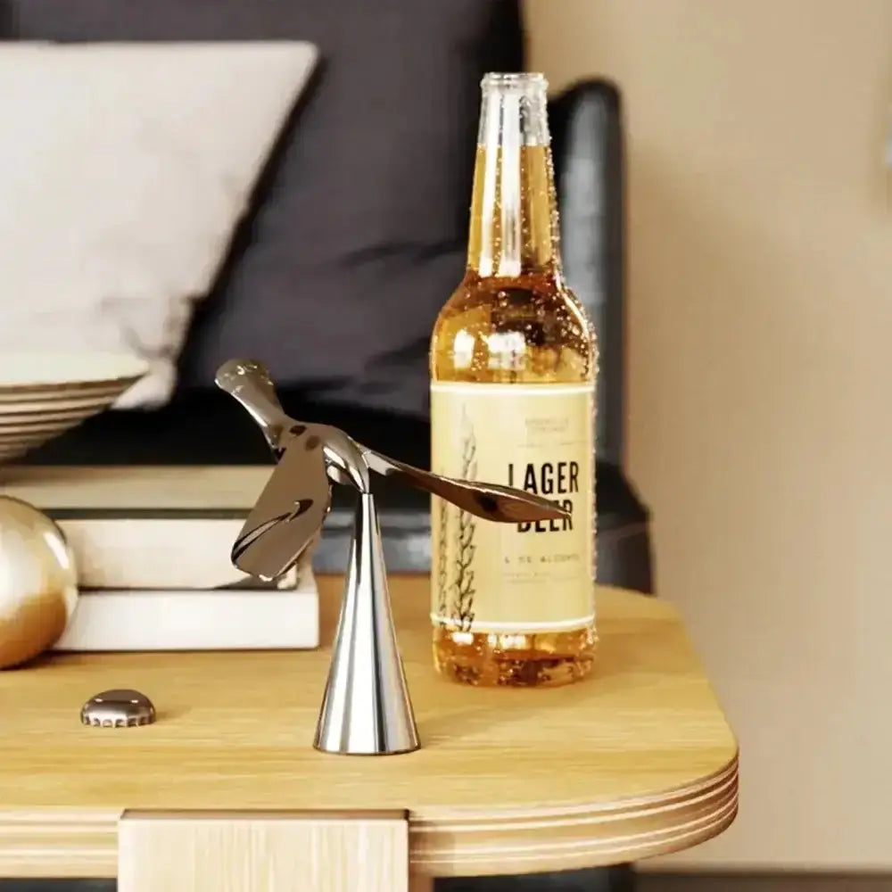 Bottle of lager beer with a bottle opener on a wooden surface