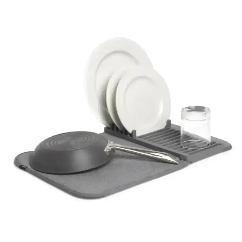 Gray dish drying rack with plates, bowls, and a frying pan on a white background