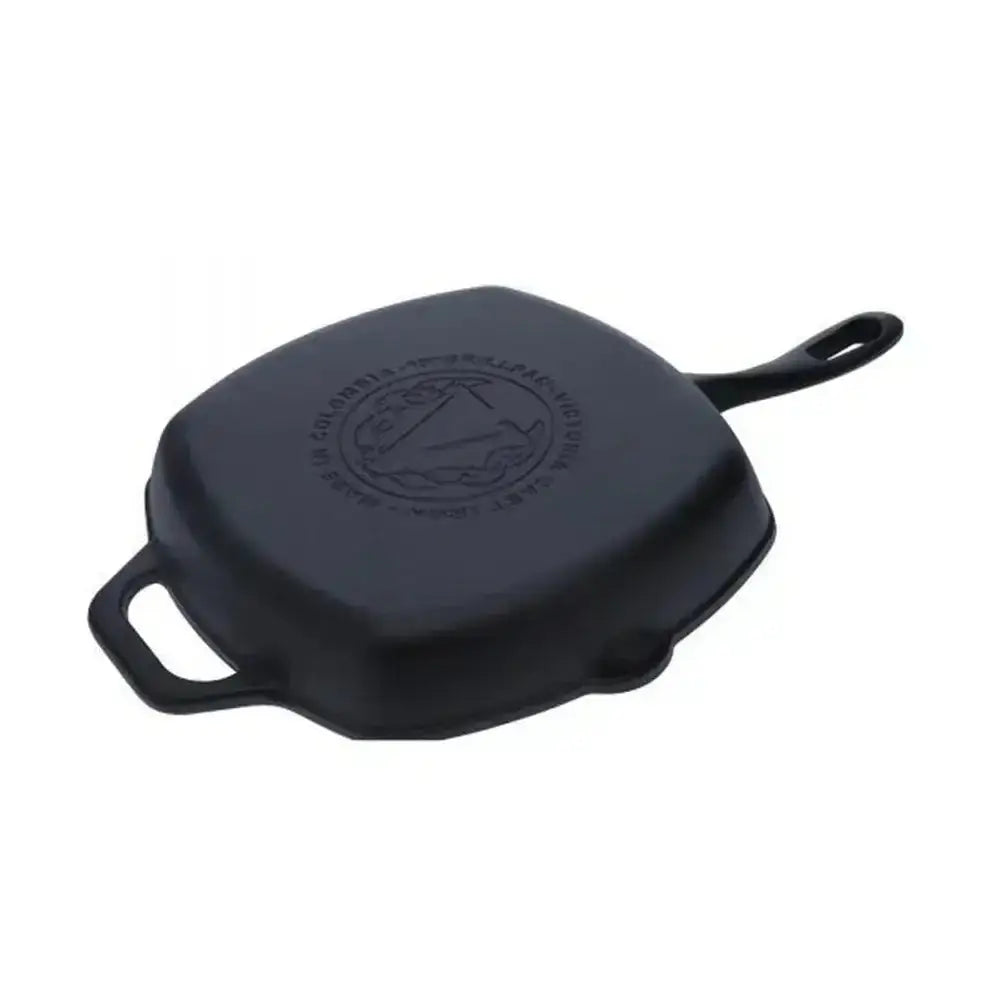 Black cast iron skillet with handle on a white background