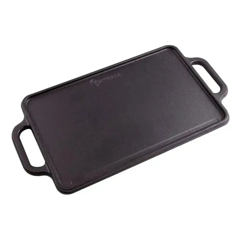 Black cast iron griddle with handles on a white background