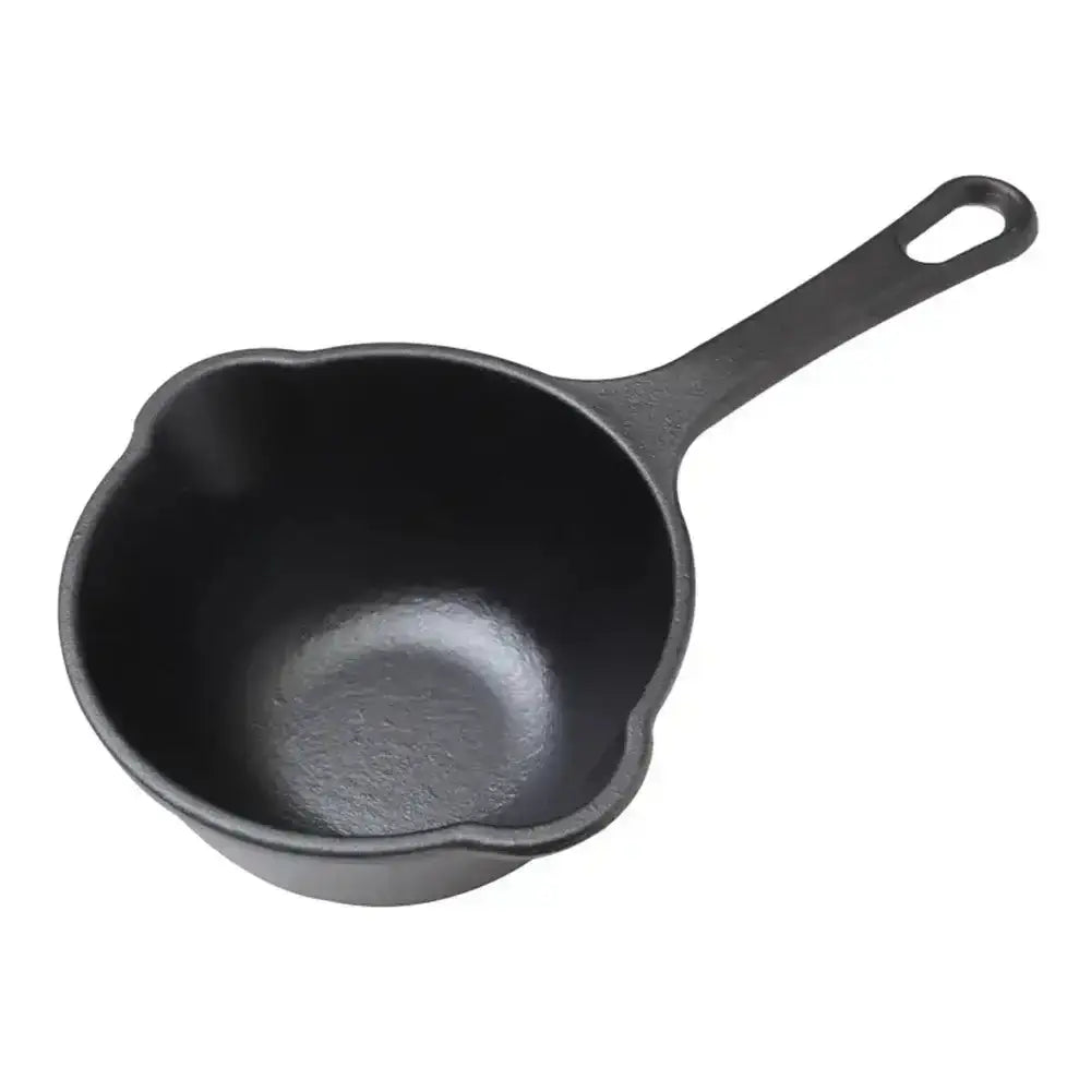 Black cast iron skillet on a white background