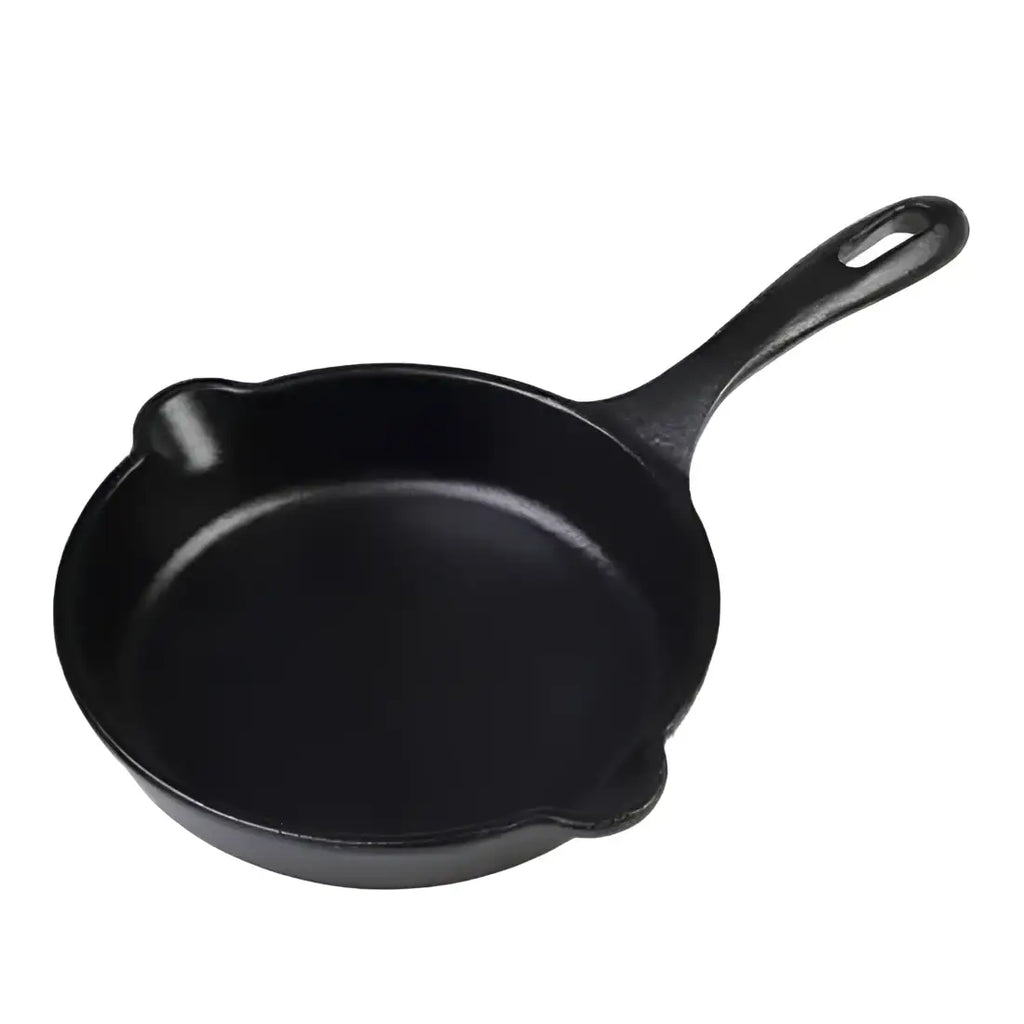 Black cast iron skillet on a white background