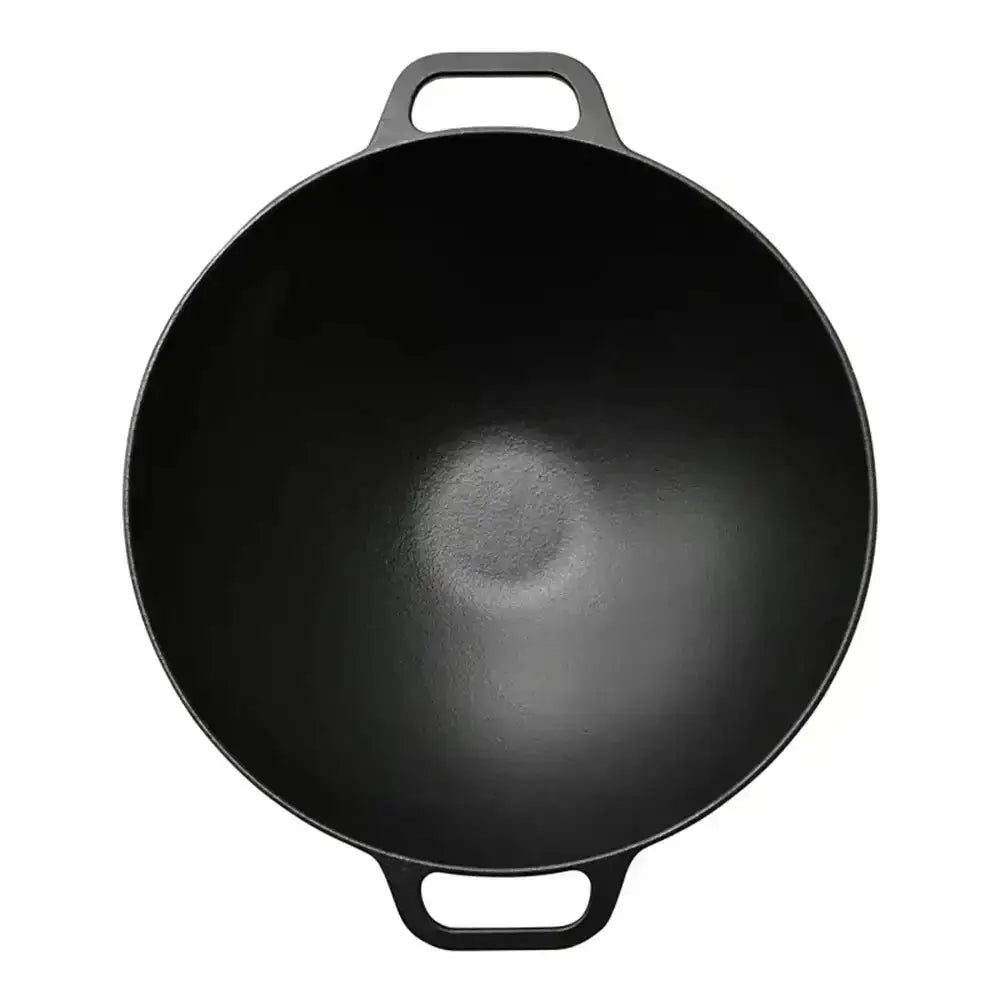 Black cast iron wok on a white background