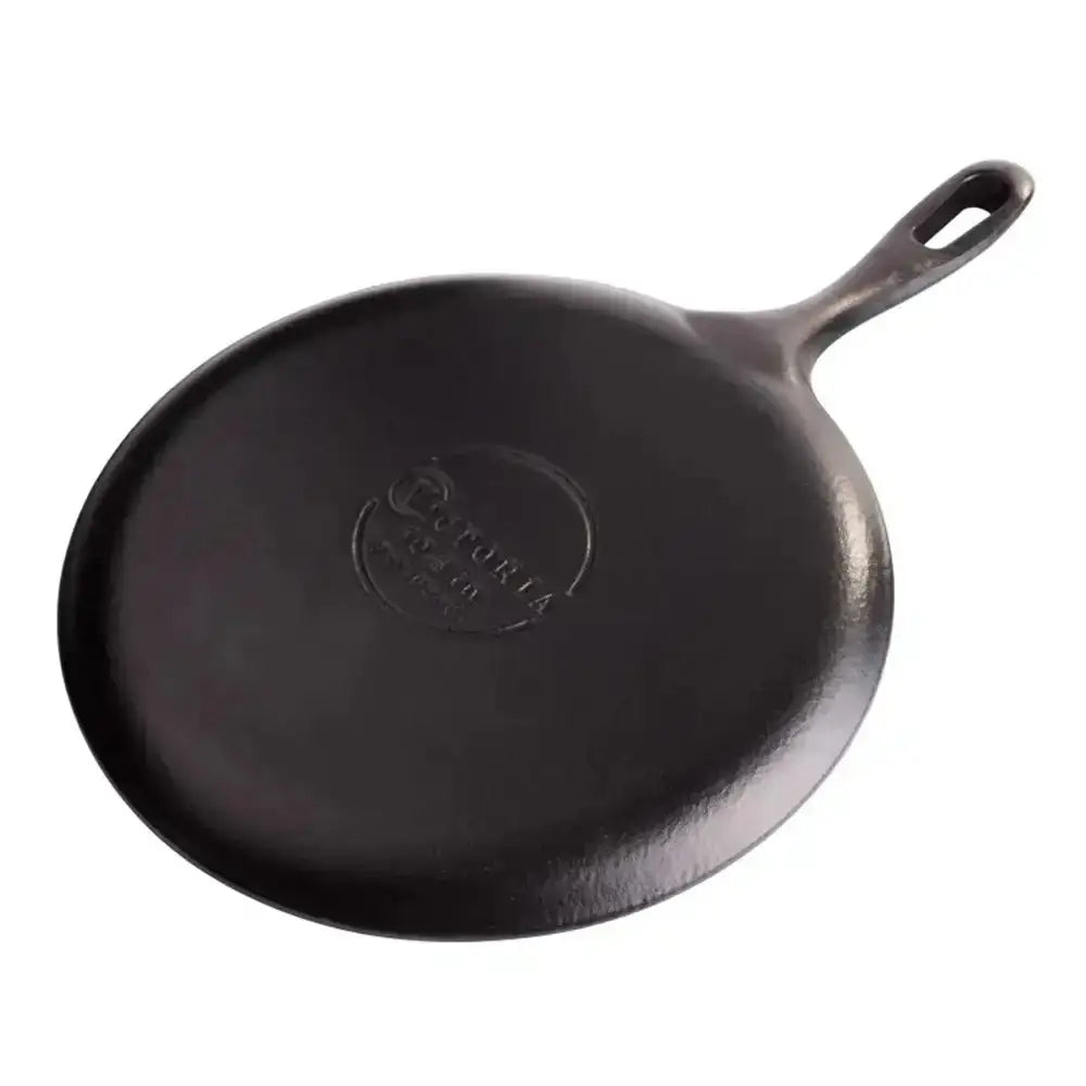 Black cast iron skillet with a handle on a white background