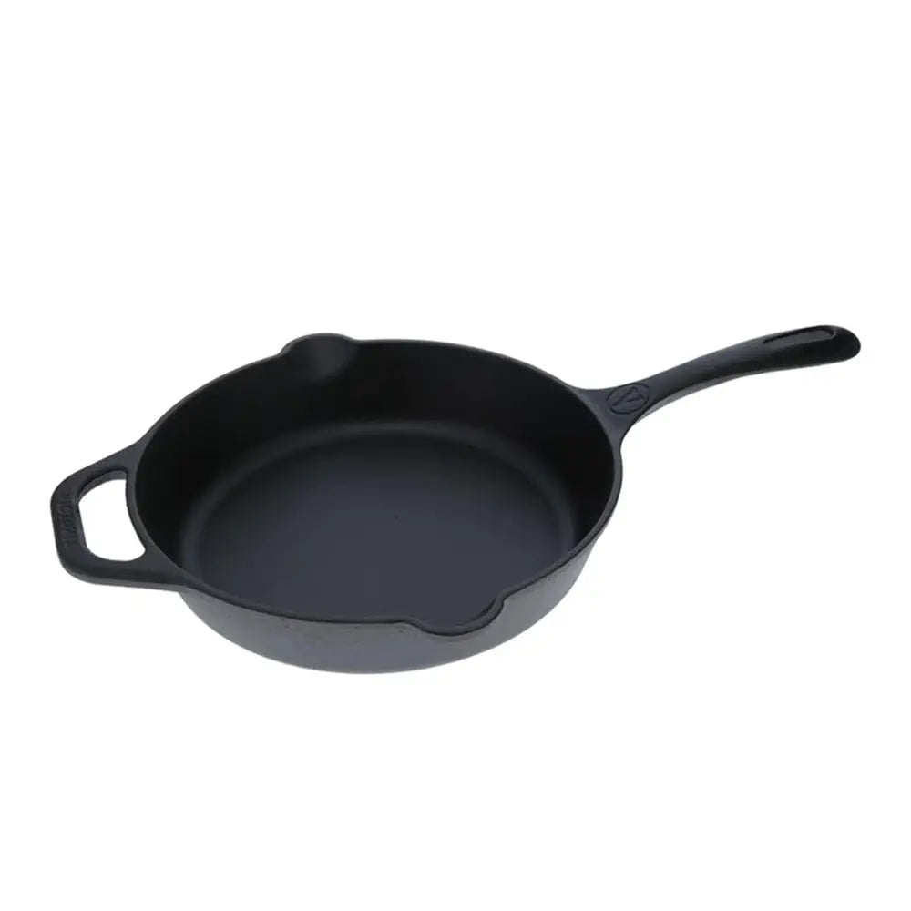 Black cast iron skillet on a white background