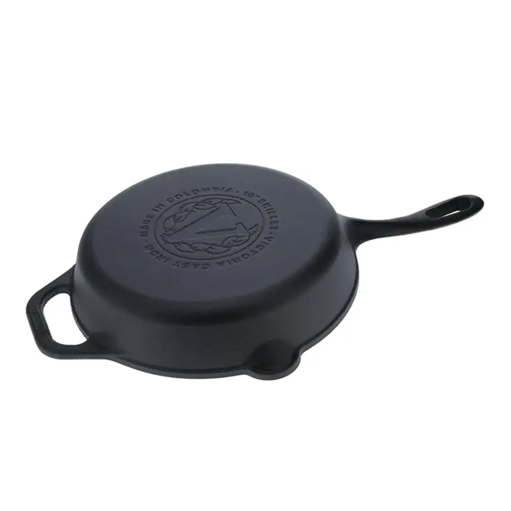 Black cast iron skillet with handle on a white background