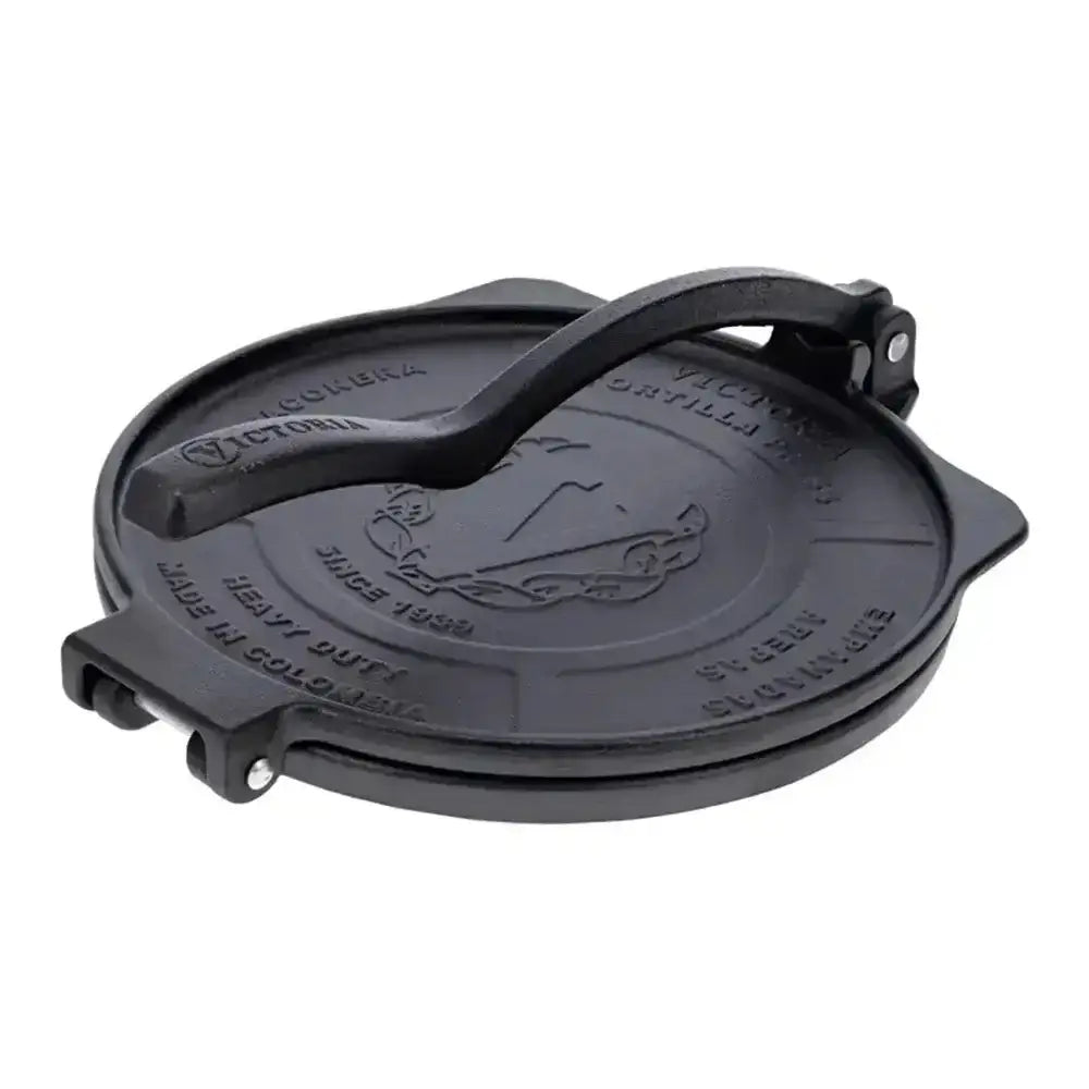 Black cast iron tortilla press on a white background