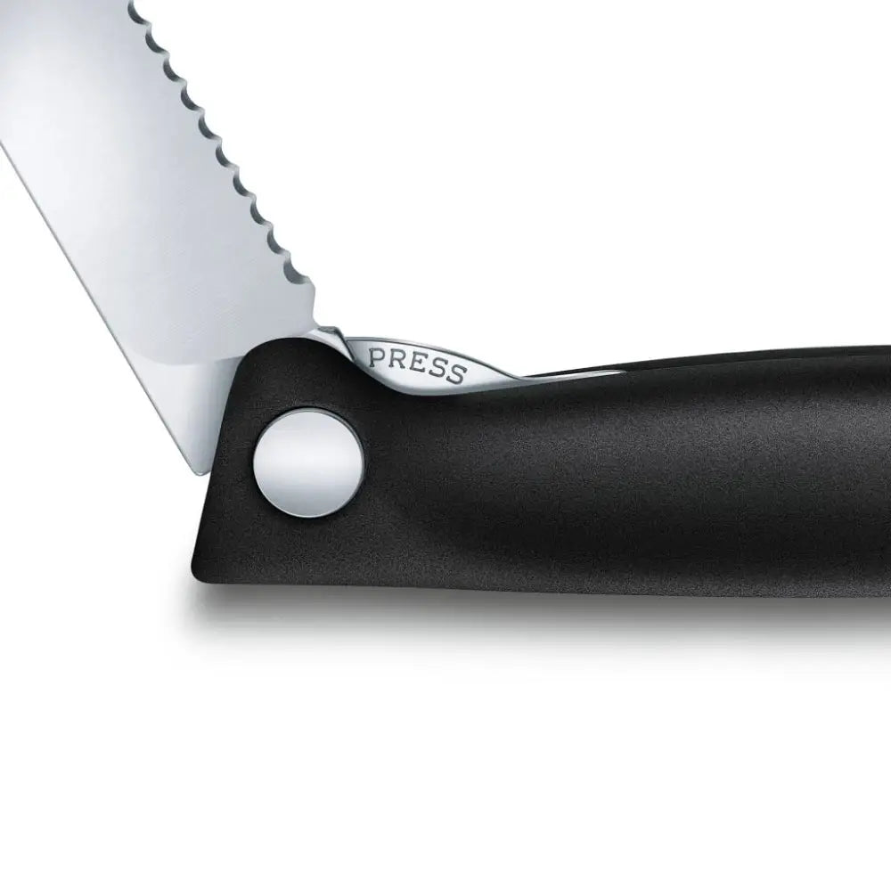Close-up of a knife with a serrated blade and black handle on a white background