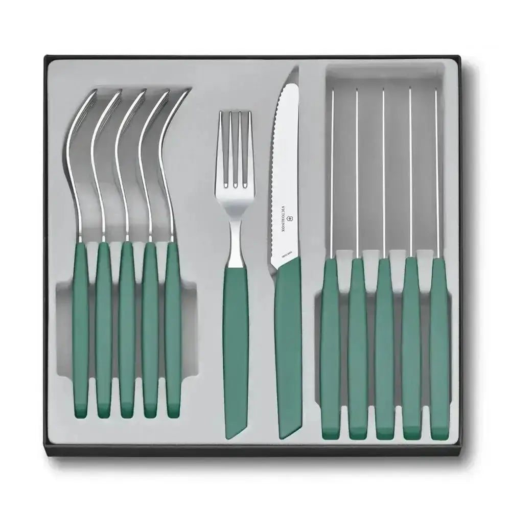 Set of silver cutlery with green handles in a box
