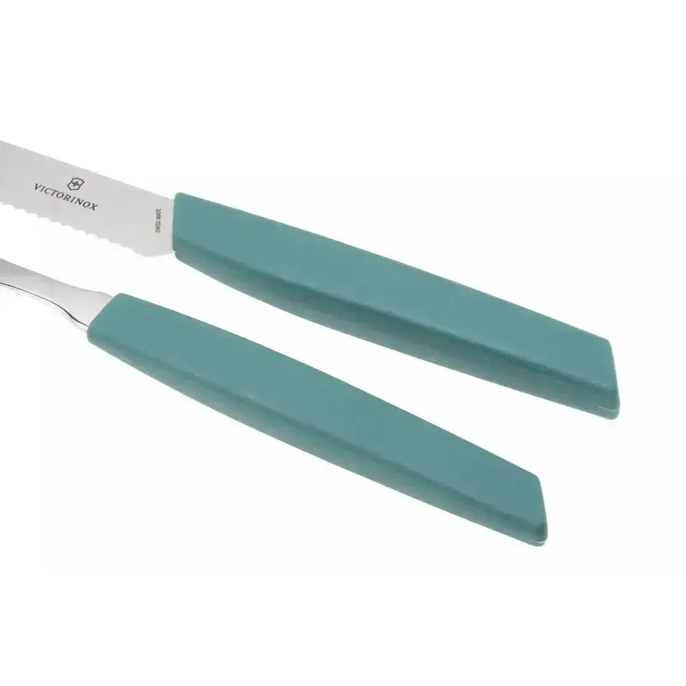 Two knives with turquoise handles on a white background, featuring the Victorinox logo.