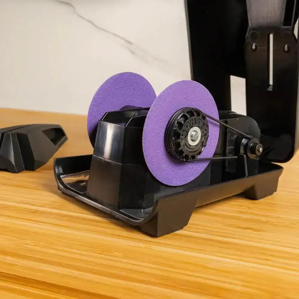 Black and purple rotary tool on a wooden surface