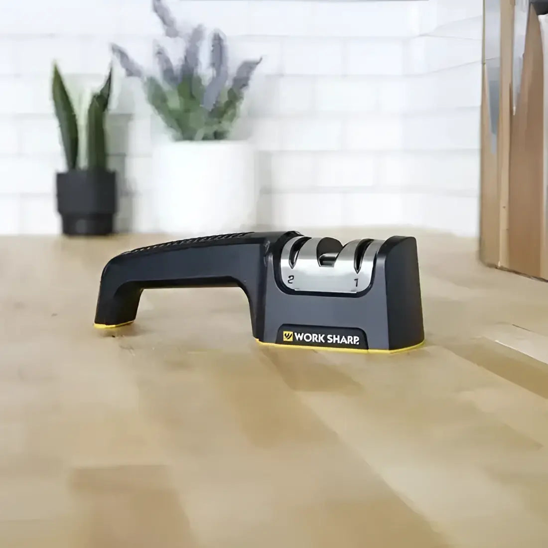 Knife sharpener on a wooden surface with a blurred indoor background